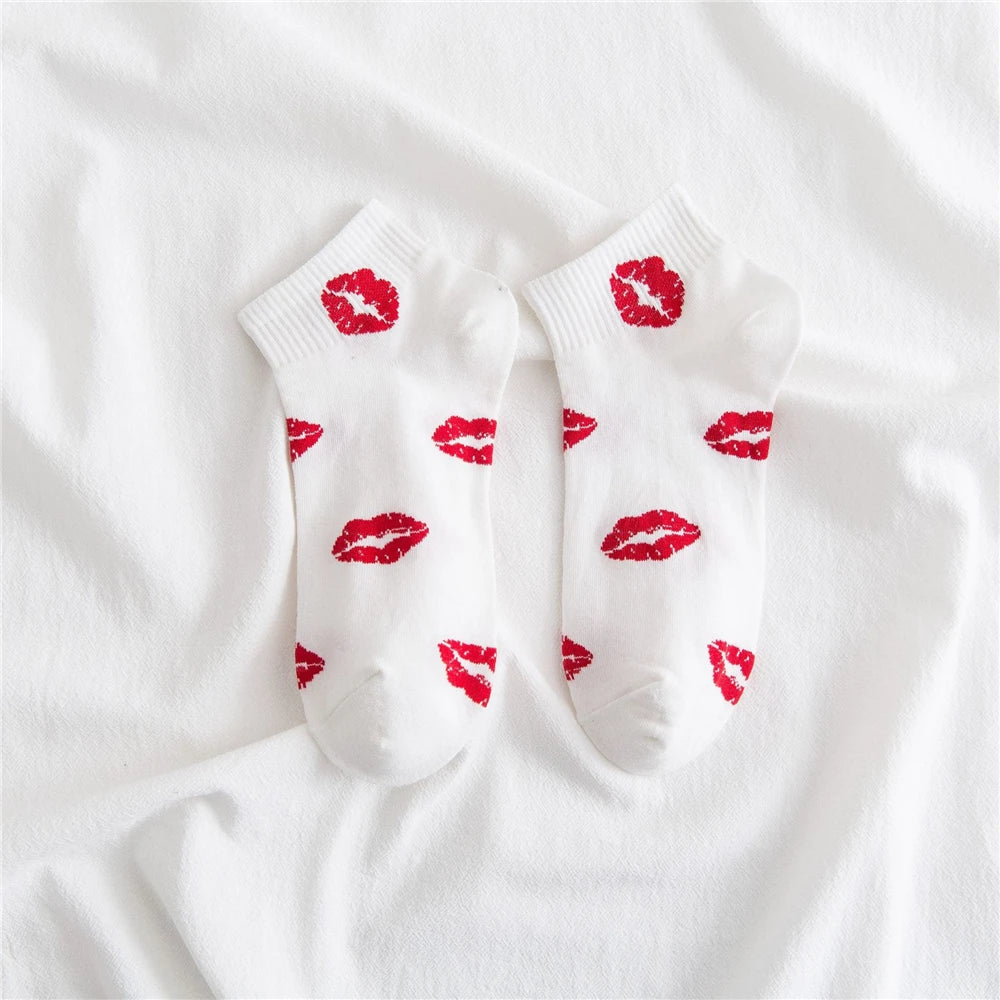 White socks with red lipstick print on the toes and heel