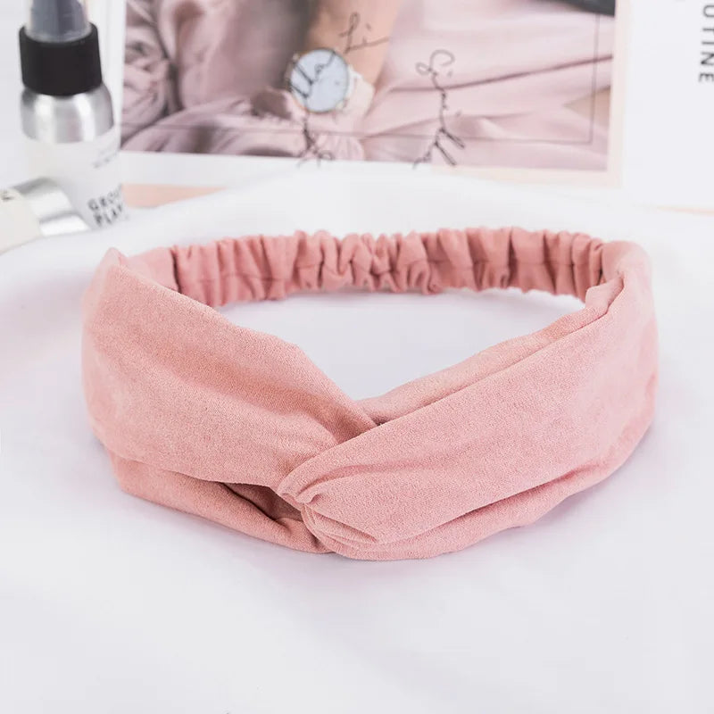 A soft dusty rose bohemian chiffon headband tied in a knot, displayed on a white surface.