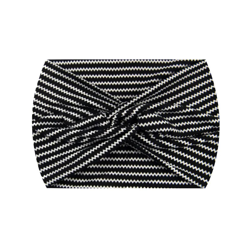 A black and white zigzag patterned wide knotted headband.
