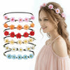 A woman wearing a pink floral rose wreath crown headpiece with light brown hair.