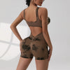 A model wearing a brown tie-dye sport jumpsuit, shown from the back and side.