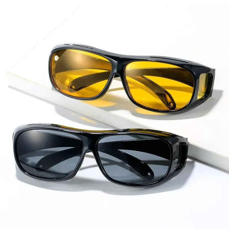 A pair of yellow tinted night vision driving sunglasses displayed on a white background.