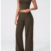 A woman models a pair of dark olive green flared high-waist yoga and fitness pants.