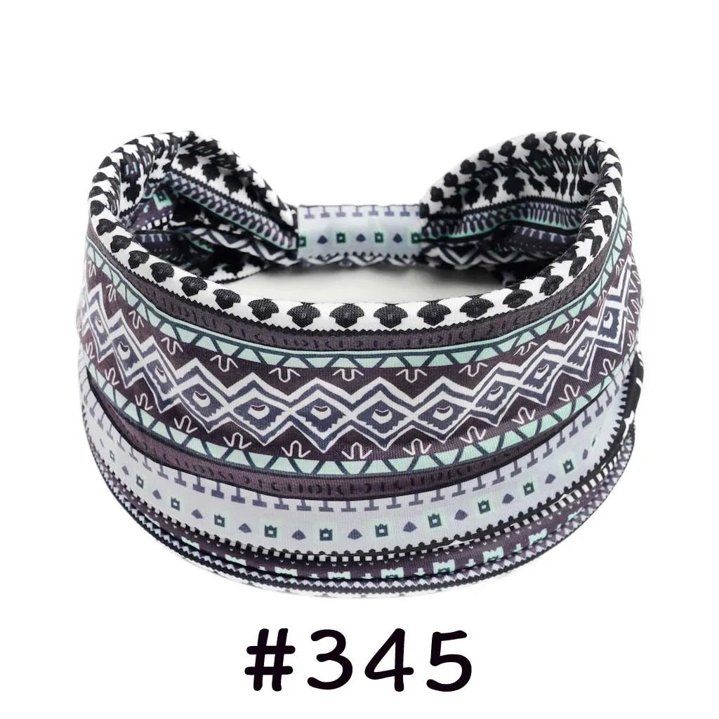 A patterned boho knotted cotton headband featuring geometric designs in shades of gray, black, and teal.