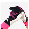 A close-up view of pink and black goalkeeper gloves with textured fabric on a hand.
