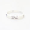 A white silicone wristband with the number 77 printed on it.