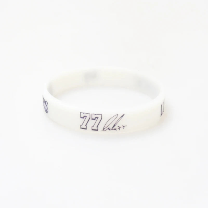 A white silicone wristband with the number 77 printed on it.