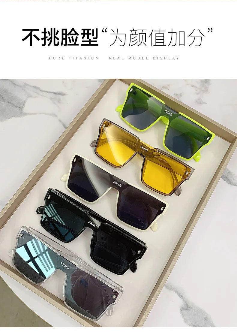A display of various FENG pure titanium sunglasses in yellow, green, and black shades.