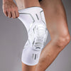 A white compression knee brace with metallic accents is worn on a person's leg.