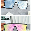 Pair of retro square sunglasses with a blue sky print and a pink floral print.