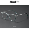 A pair of clear acetate glasses with a thin metal frame shown at a 45-degree side angle.