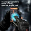 A hand wearing black thermal gloves is using a ten-finger sensitive touch screen device on a smartphone.