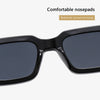 A pair of black sunglasses with a dark gray lens shown in a close-up view.