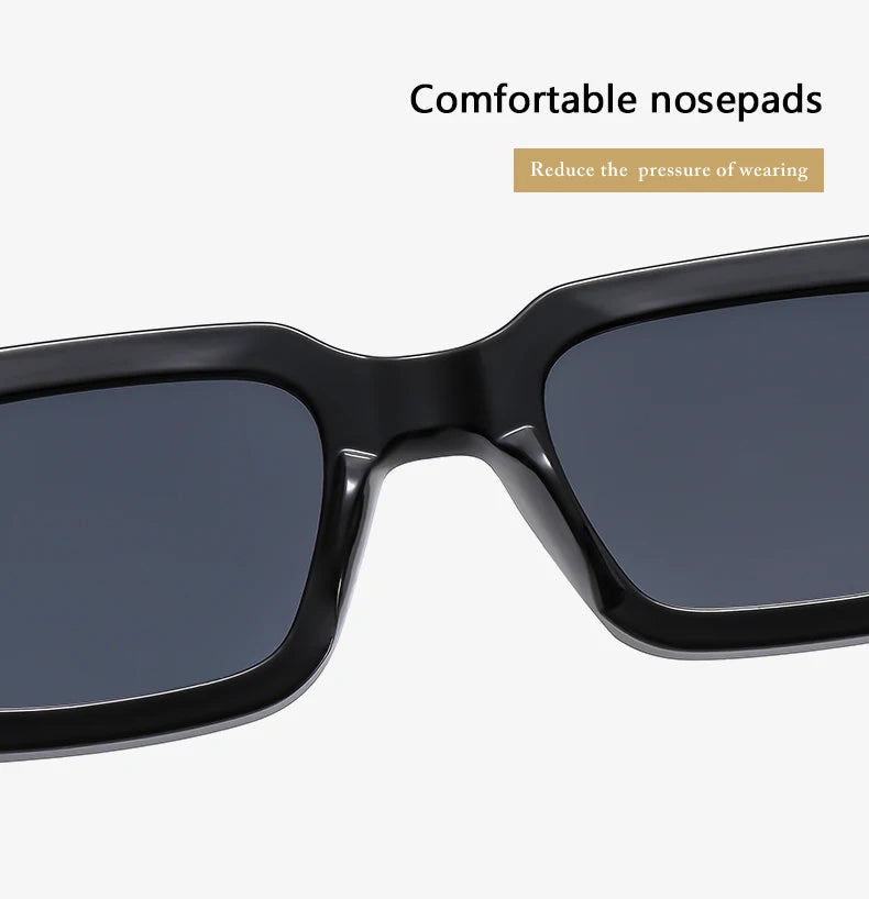 A pair of black sunglasses with a dark gray lens shown in a close-up view.