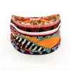 A colorful bohemian stretch cotton headband featuring various animal and geometric patterns in orange, black, and white.