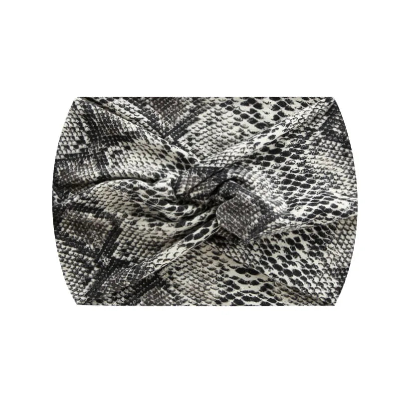 A black and white patterned fabric wide knotted headband