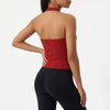 A woman wearing a red seamless yoga sports bra and black leggings, shown from the back.