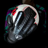 Black leather goalkeeper gloves with an Atlander logo placed on a white soccer ball.