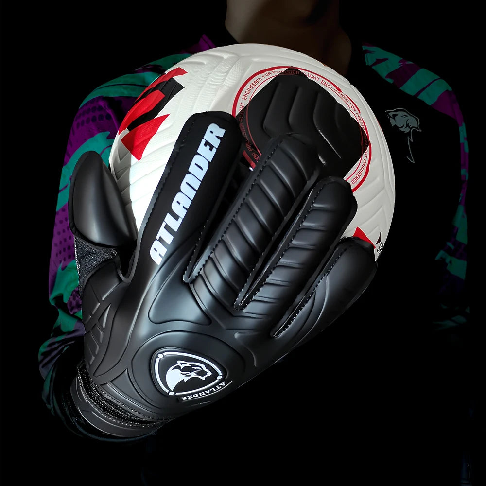 Black leather goalkeeper gloves with an Atlander logo placed on a white soccer ball.