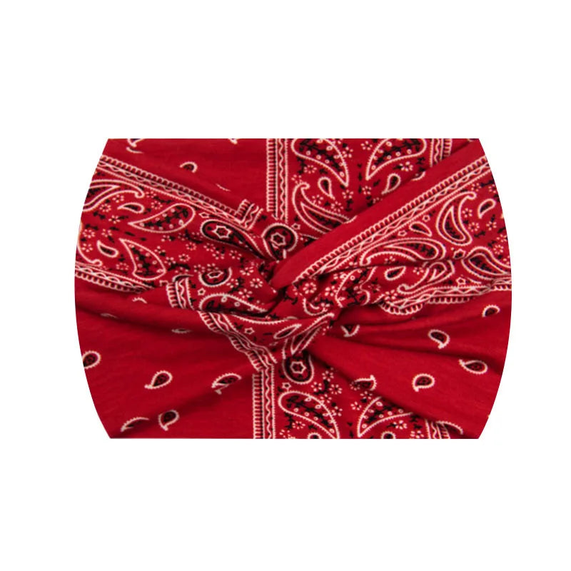 Bandeau de sport rouge à imprimé stretch avec motifs paisley blancs complexes.