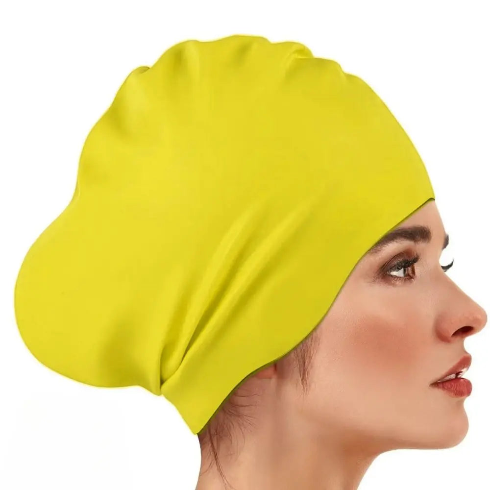 A bright yellow silicone swim cap worn on a woman's head, shown in profile.