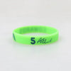 A bright lime green silicone wristband with the number 5 and the text ASL printed on it.