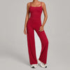 A woman wearing a long-sleeved, high-waist red yoga and fitness tracksuit set.