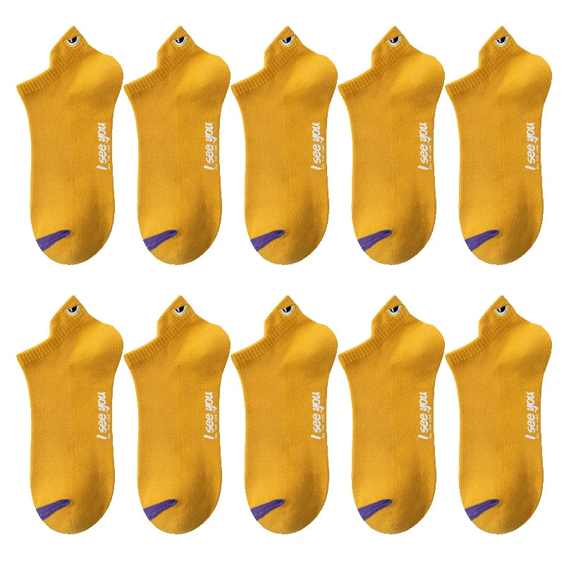 A set of yellow men's breathable ankle boat socks with purple accents.