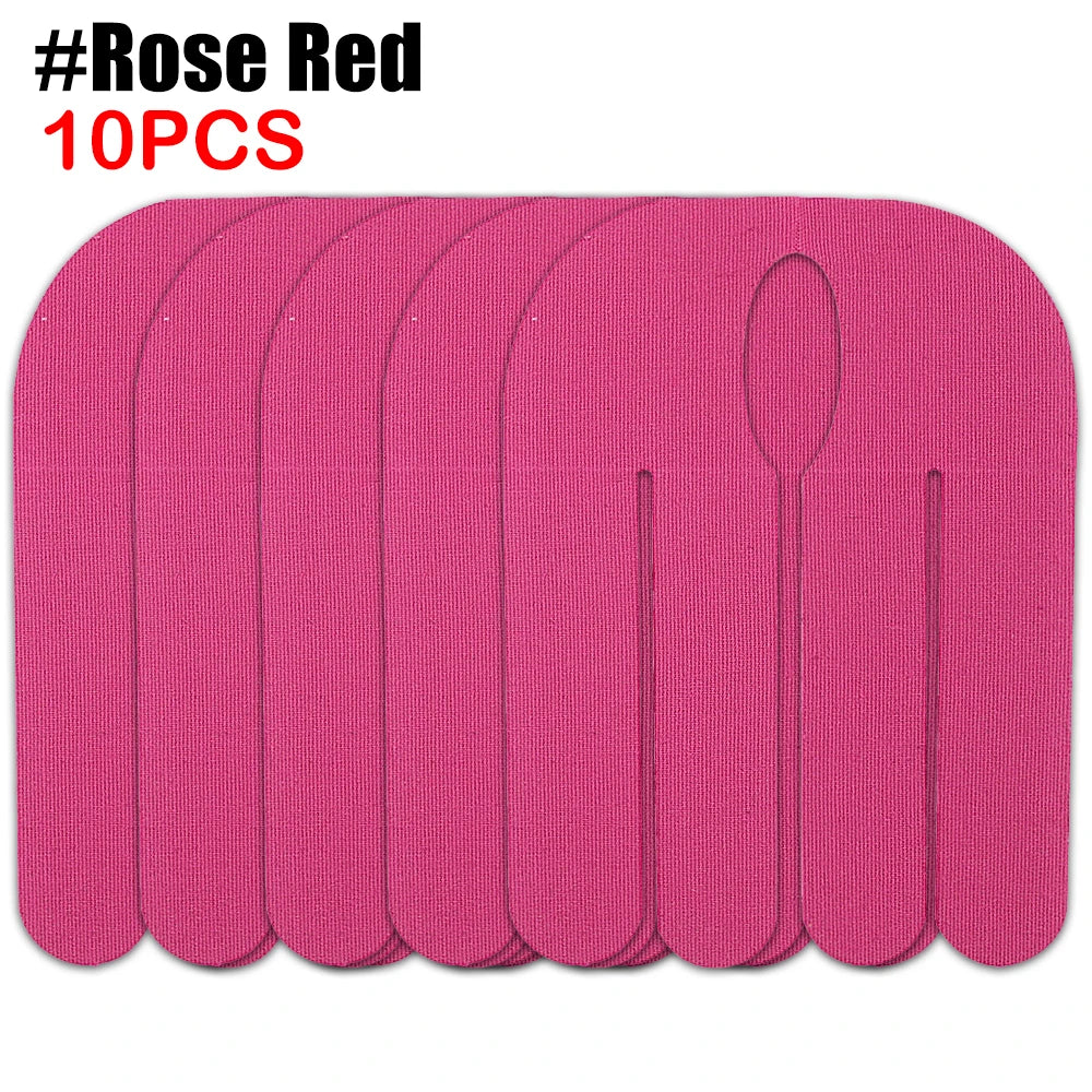 Ten pink kinesiology tapes arranged in a row for sports recovery.