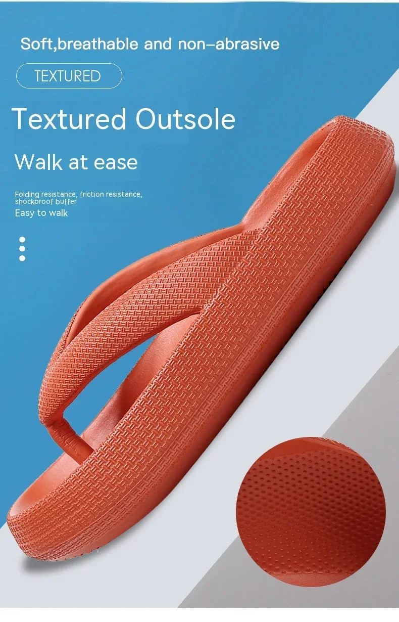 An orange textured outsole of comfort platform flip flops shown in a close-up view.