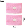 A pair of pink knitted wristbands with a circular button for anti-nausea relief.