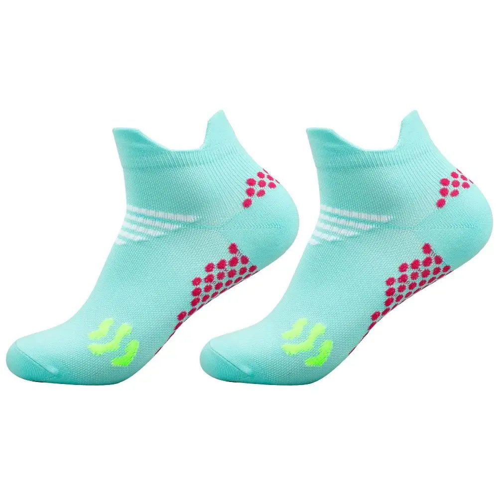 A pair of light blue cycling and running socks with pink and white patterns.