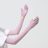 A model is wearing light pink UPF 50+ sun protection arm sleeves on both arms.