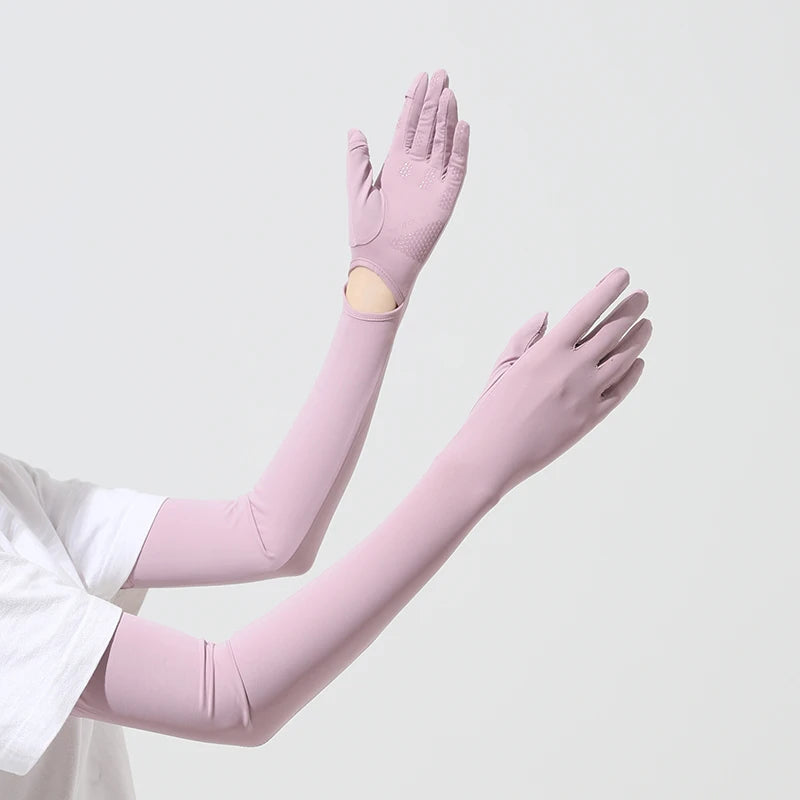 A model is wearing light pink UPF 50+ sun protection arm sleeves on both arms.