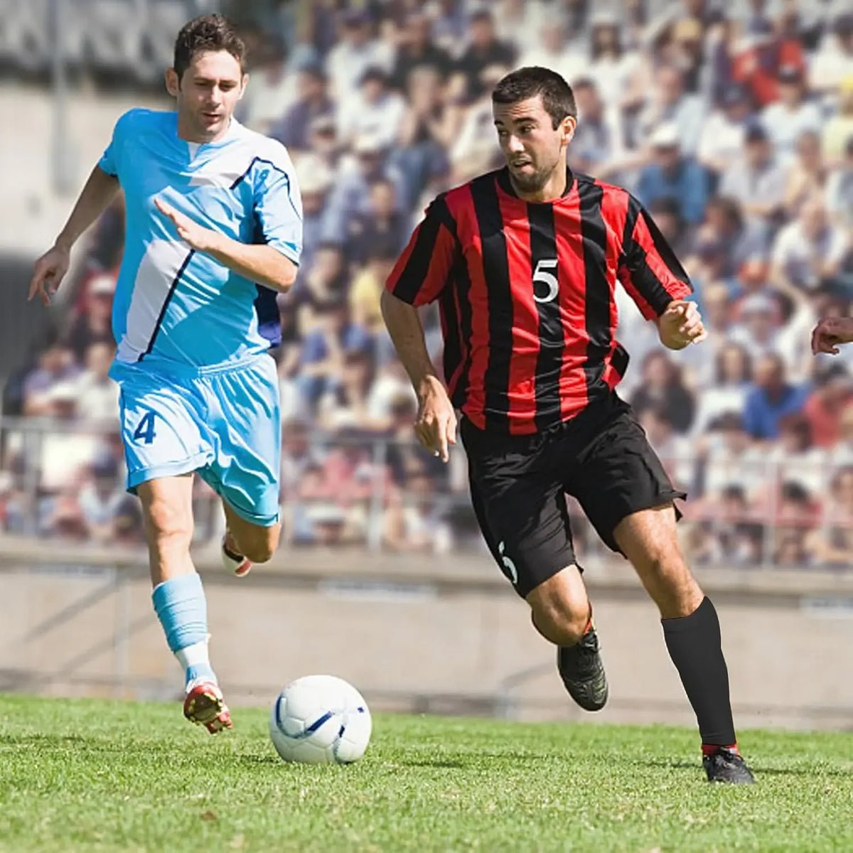 Two male football players in jerseys and shorts are running on a green field during a match.