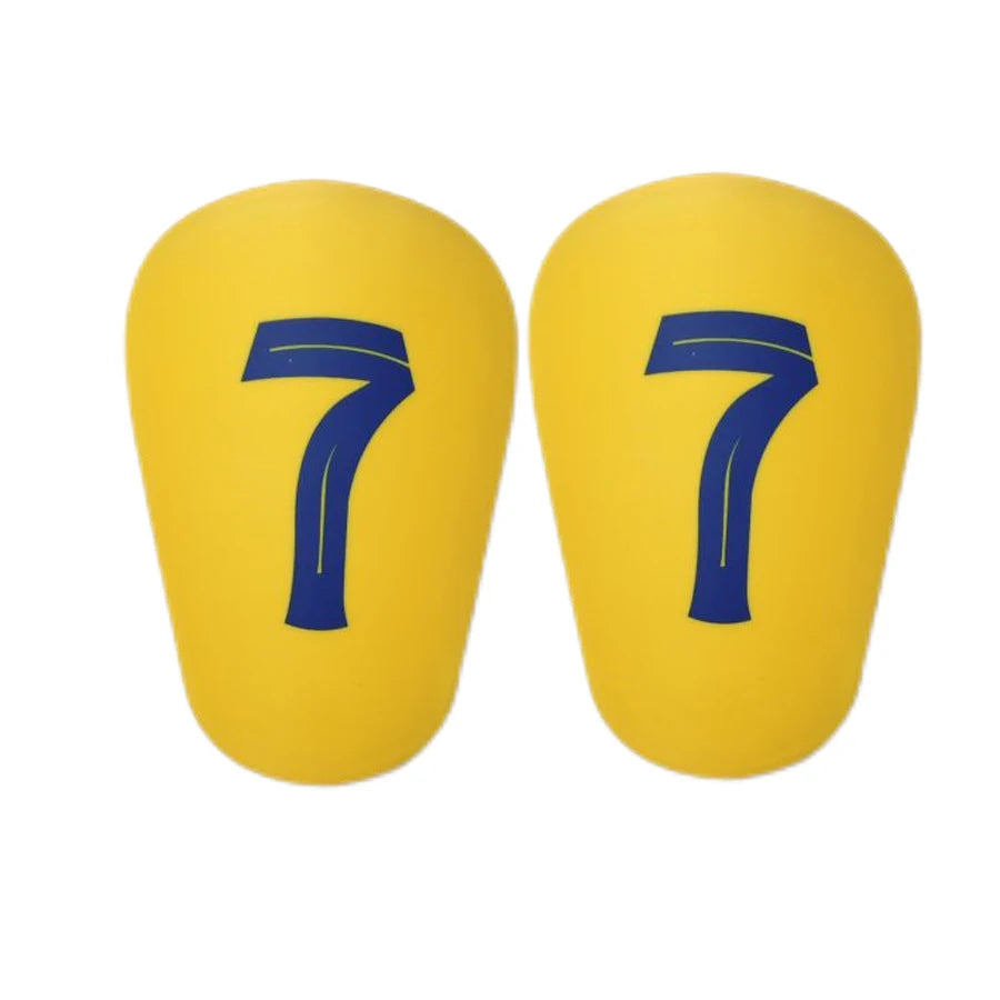 A pair of yellow mini football shin guards with the number 7 printed in blue on each.