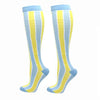 A pair of light blue and yellow striped compression elastic socks for sports and daily wear.