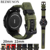 A watch with a black case and olive green nylon quick release band is shown alongside various strap sizes.