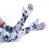 A hand wearing a long-sleeved camouflage pattern sun protection arm sleeve.