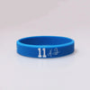 A bright blue silicone wristband with the number 11 and a signature engraved on the surface.