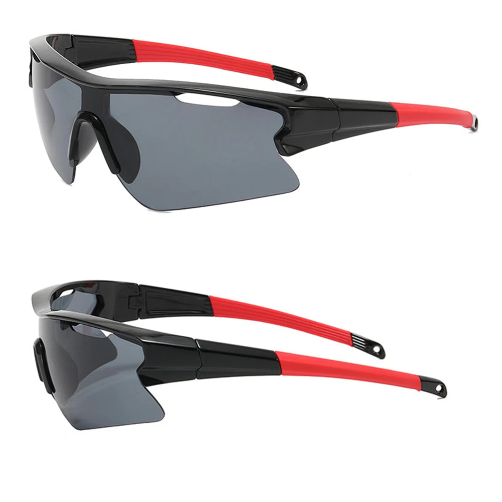 A pair of black and gray sport sunglasses with red accents shown in a profile view.