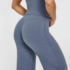 A person wearing a solid blue-gray high-waist yoga pant and matching top.