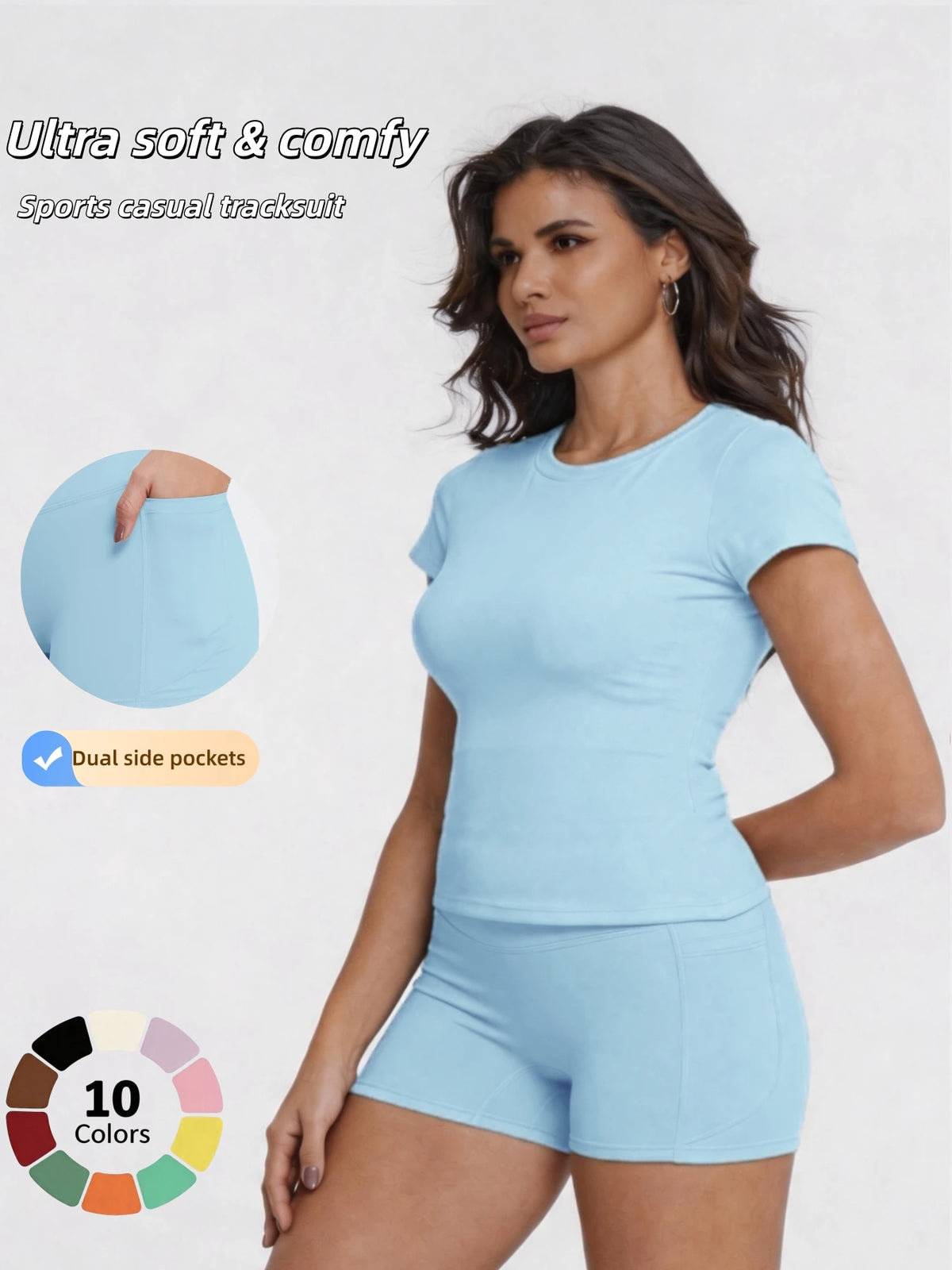 A woman models a light blue sports casual tracksuit top and shorts, showcasing the garment details.