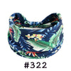 A navy blue floral patterned fabric headband tied in a bow.