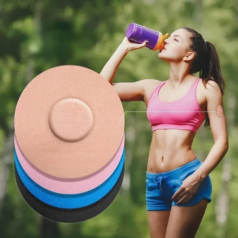 A woman is applying a reusable adhesive patch to her skin outdoors.