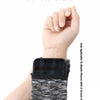 A black zippered front pocket wrist bag designed to hold essentials like a phone, keys, and cards.