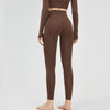 A model is wearing high-waist seamless yoga leggings in a brown color.