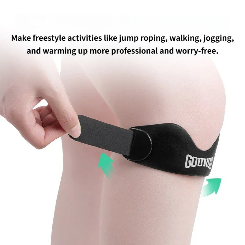 A hand is adjusting a black silicone patellar strap for knee support on a person's leg.