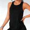 A woman wearing a black breathable sport tank top and matching bottoms, posing for a photo.