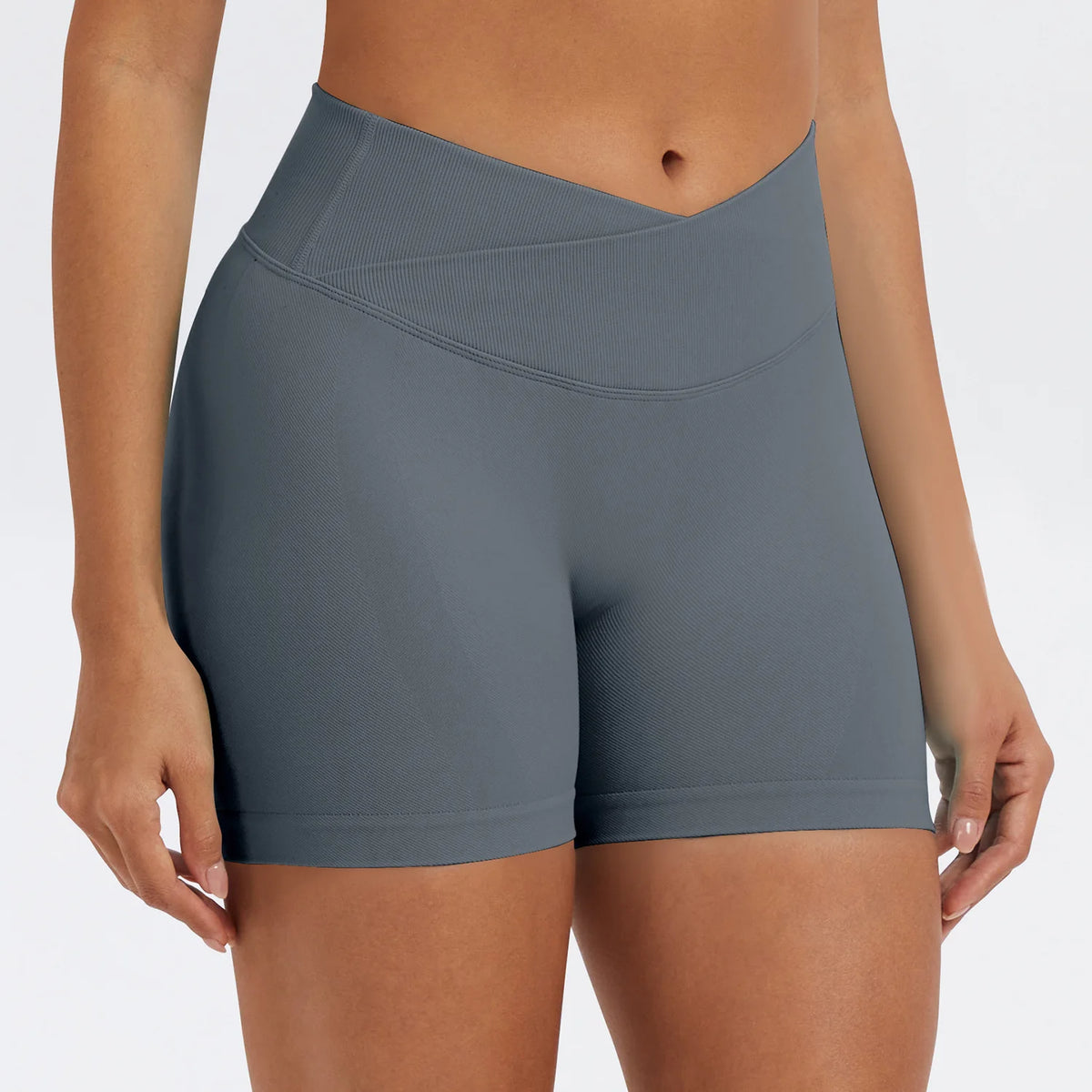 A model wearing seamless high-waist yoga leggings in a slate gray color.